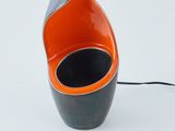 an orange and black vase with a black lid