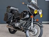 a black motorcycle parked in front of a garage door