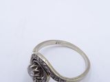 a close up of a silver ring on a white surface