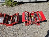 a red tool box with tools in it on the ground