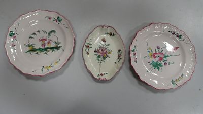 three plates with floral designs are sitting on a white surface