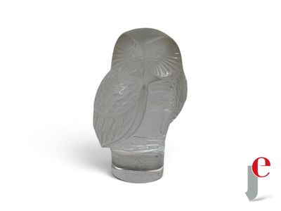 an image of a gray owl statue sitting on top of a white surface