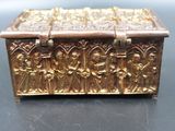 an antique brass box with carvings on it sitting on a table