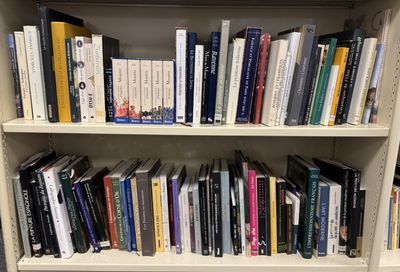 a book shelf with many books on it in a library