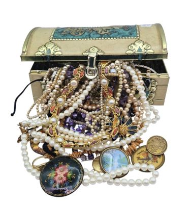 a chest full of assorted jewelry on a white background