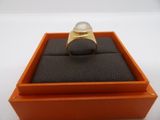 an orange box with a ring inside of it on a white surface
