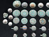 many pieces of pottery that are sitting on a black surface