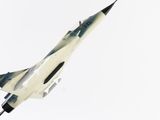 a model of a fighter jet on a white surface