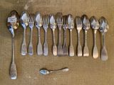 a lot of silver spoons and forks on the table