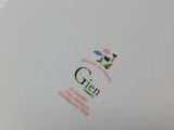 a close up of a white plate with a green design on it