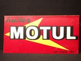 une ancienne enseigne Motul est affichée sur un fond noir