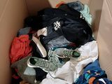 a cardboard box filled with clothes and a pair of shoes