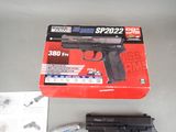 a gun that is sitting on a table next to a package