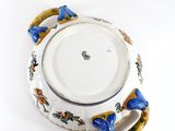a white bowl with blue flowers on it sitting on a table