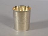 a silver cup that is sitting on a table