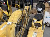 several yellow hoses are stacked on top of each other in a warehouse