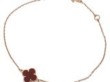 an image of a bracelet with a red flower on it