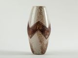 a brown and white vase sitting on a white surface