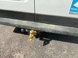 a yellow fire hydrant sitting on the ground next to a car