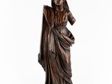 a bronze statue of a woman in a dress