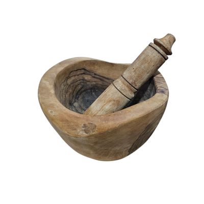a mortar and a pestor in a wooden bowl