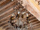 a chandelier hanging from a wooden ceiling in a room