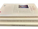 three books stacked on top of each other on a white surface