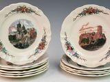 four plates with a picture of a castle on them