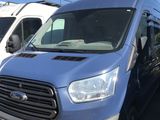 a blue van that is parked in a parking lot