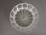 a clear glass bowl with a circular design on it
