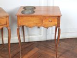 two wooden tables with a bowl on top of them