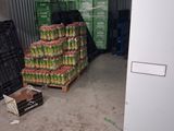 many crates of fruit in a storage area next to each other