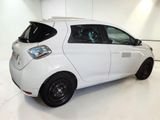 a picture of a small white car parked in a garage