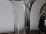 two vases sitting on a table next to each other
