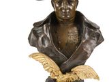 bronze bust of a man with a hat and eagle on a base