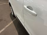 a white car that is parked in a parking lot