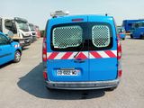a blue van that is parked in a parking lot