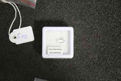 a small white box with a ring on top of it
