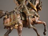 bronze statue of a man on a horse with a sword in his hand