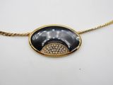 a black and gold necklace with diamonds on a gold chain