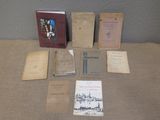 an assortment of old books are sitting on a table