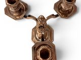 pair of antique brass candlesticks on a white background