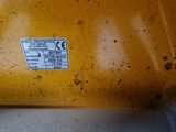 a close up of a yellow machine with a sticker on it ' s side