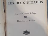 opened book on a blue table with a red and white cover