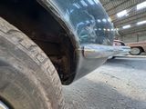 a close up view of a car ' s bumper and tire