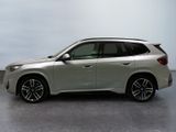 the bmw x1 is parked in a white room