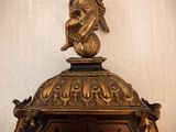 a clock that has a statue on top of it