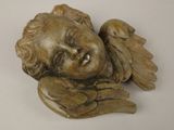 a statue of an angel with wings on a white surface