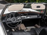 a white car with a black leather seat and dashboard