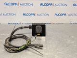 a close up of an electrical device on a table in front of a sign